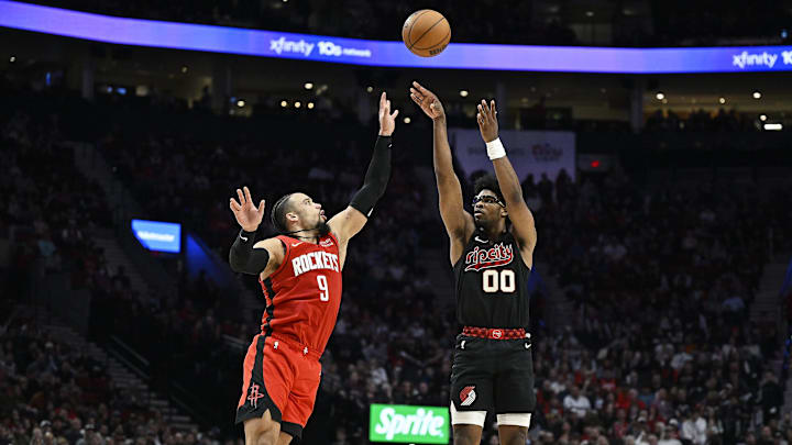 Apr 12, 2024; Portland, Oregon, USA; Portland Trail Blazers guard Scoot Henderson (00) shoots a three point basket during the second half against Houston Rockets forward Dillon Brooks (9) at Moda Center. Mandatory Credit: Troy Wayrynen-Imagn Images