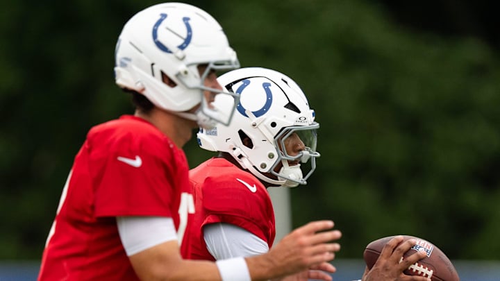 Indianapolis Colts quarterbacks Anthony Richardson Sr. (5) and Daniel Jones (17) drop back to pass Monday, July 28, 2025, during training camp held at Grand Park in Westfield.