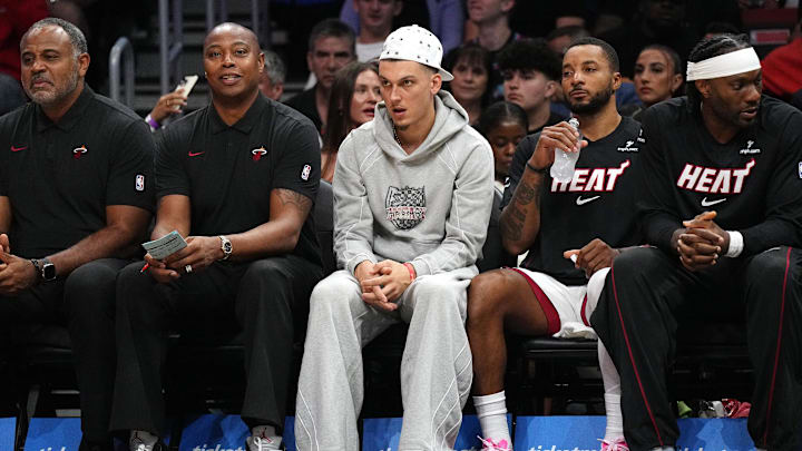 Oct 8, 2025; Miami, Florida, USA; Miami Heat guard Tyler Herro, center, watches the game against the San Antonio Spurs from the bench at Kaseya Center as he recovers from an injury. Mandatory Credit: Jim Rassol-Imagn Images Oct 8, 2025; Miami, Florida, USA; Miami Heat guard Tyler Herro, center, watches the game against the San Antonio Spurs from the bench at Kaseya Center as he recovers from an injury. Mandatory Credit: Jim Rassol-Imagn Images