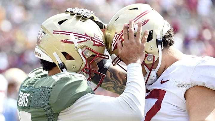 Apr 15, 2023; Tallahassee, FL, USA; Florida State Seminoles quarterback Jordan Travis (13) meets with offensive lineman Julian Armella (72) at Doak Campbell Stadium. Mandatory Credit: Melina Myers-Imagn Images