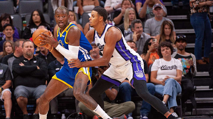 Oct 9, 2024; Sacramento, California, USA; Sacramento Kings forward Keegan Murray (13) defends against Golden State Warriors forward Jonathan Kuminga (00) during the first quarter at Golden 1 Center. Mandatory Credit: Ed Szczepanski-Imagn Images