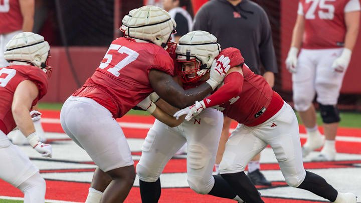 Nebraska offensive lineman Elijah Pritchett battles a double team from fellow lineman Brock Knutson and tight end Luke Lindenmeyer during a drill.