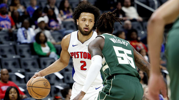 Oct 6, 2024; Detroit, Michigan, USA;  Detroit Pistons guard Cade Cunningham (2) dribbles defended by Milwaukee Bucks guard Delon Wright (55) in the first half at Little Caesars Arena. Mandatory Credit: Rick Osentoski-Imagn Images