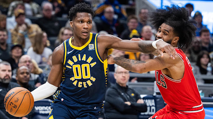 Jan 8, 2025; Indianapolis, Indiana, USA; Indiana Pacers guard Bennedict Mathurin (00) dribbles the ball while Chicago Bulls guard Coby White (0) defends in the second half at Gainbridge Fieldhouse. Mandatory Credit: Trevor Ruszkowski-Imagn Images