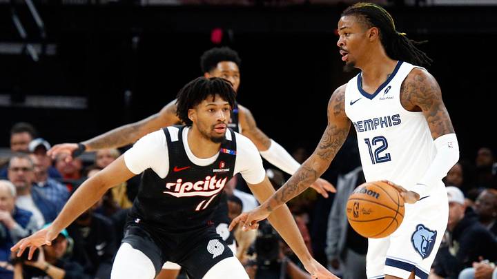 Nov 25, 2024; Memphis, Tennessee, USA; Memphis Grizzlies guard Ja Morant (12) dribbles as Portland Trail Blazers guard Shaedon Sharpe (17) defends during the first half at FedExForum. Mandatory Credit: Petre Thomas-Imagn Images
