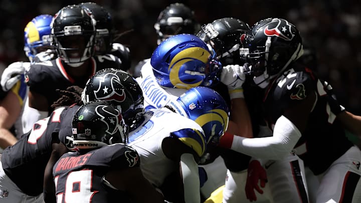 Aug 24, 2024; Houston, Texas, USA;  Los Angeles Rams running back Zach Evans (21) is gang tackled by the Houston Texans in the fourth quarter at NRG Stadium. Mandatory Credit: Thomas Shea-Imagn Images