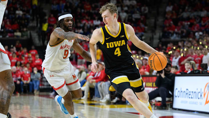 Feb 16, 2025; College Park, Maryland, USA; Iowa Hawkeyes guard Josh Dix (4) handles the ball against Maryland Terrapins guard Selton Miguel (9) during the first half at Xfinity Center. Mandatory Credit: Reggie Hildred-Imagn Images Feb 16, 2025; College Park, Maryland, USA; Iowa Hawkeyes guard Josh Dix (4) handles the ball against Maryland Terrapins guard Selton Miguel (9) during the first half at Xfinity Center. Mandatory Credit: Reggie Hildred-Imagn Images