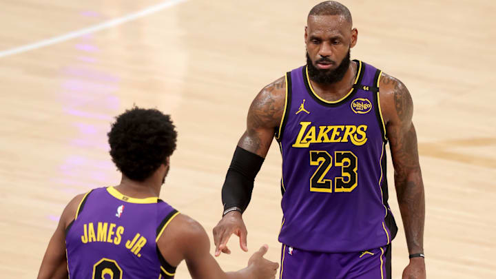 Feb 1, 2025; New York, New York, USA; Los Angeles Lakers guard Bronny James (9) checks in for forward LeBron James (23) during the fourth quarter against the New York Knicks at Madison Square Garden. Mandatory Credit: Brad Penner-Imagn Images