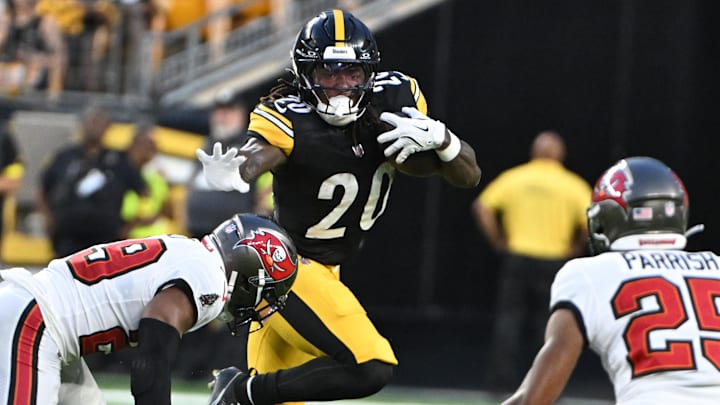 Aug 16, 2025; Pittsburgh, Pennsylvania, USA; Pittsburgh Steelers running back Kaleb Johnson (20) looks to stiff arm Tampa Bay Buccaneers safety Christian Izien (29) during the second quarter at Acrisure Stadium. Aug 16, 2025; Pittsburgh, Pennsylvania, USA; Pittsburgh Steelers running back Kaleb Johnson (20) looks to stiff arm Tampa Bay Buccaneers safety Christian Izien (29) during the second quarter at Acrisure Stadium.