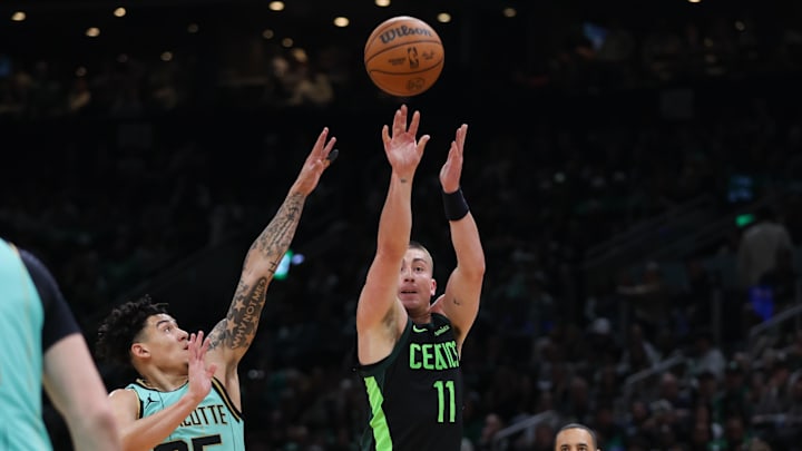 Apr 13, 2025; Boston, Massachusetts, USA; Boston Celtics guard Payton Pritchard (11) shoots during the first half against the Charlotte Hornets at TD Garden. Mandatory Credit: Paul Rutherford-Imagn Images