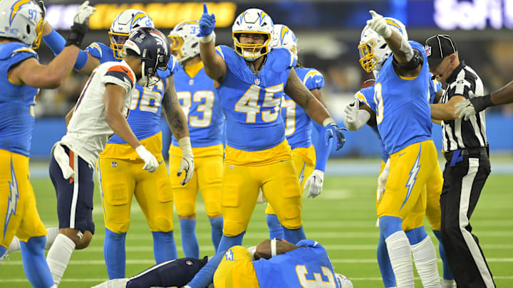 Los Angeles Chargers linebacker Tuli Tuipulotu signals after a fumble recovery against the Denver Broncos at SoFi Stadium.