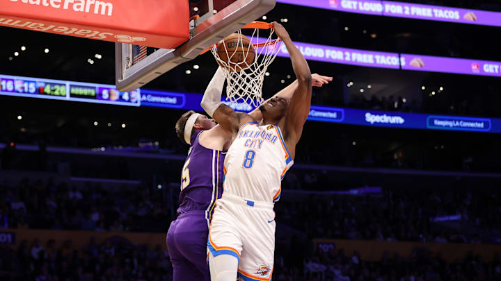 Feb 9, 2026; Los Angeles, California, USA;  Oklahoma City Thunder guard Jalen Williams (8) dunks the ball over Los Angeles Lakers guard Austin Reaves (15) during the first half at Crypto.com Arena. Mandatory Credit: Kiyoshi Mio-Imagn Images