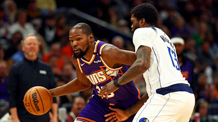 Phoenix Suns forward Kevin Durant (35) drives to the basket against Dallas Mavericks forward Naji Marshall (13) during the second quarter at Footprint Center.
