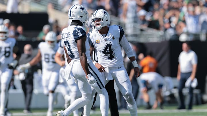 Oct 5, 2025; East Rutherford, New Jersey, USA; Dallas Cowboys quarterback Dak Prescott (4) reacts with wide receiver George Pickens (3) after throwing a touchdown pass against the New York Jets during the first half at MetLife Stadium. Mandatory Credit: Vincent Carchietta-Imagn Images