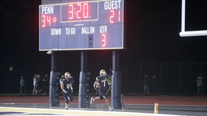Penn receiver Tayshon Bardo (1) runs by the scoreboard after his touchdown Friday, Aug. 23, 2024, at the Valparaiso vs. Penn football game at Freed Field. Penn receiver Tayshon Bardo (1) runs by the scoreboard after his touchdown Friday, Aug. 23, 2024, at the Valparaiso vs. Penn football game at Freed Field.