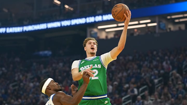 Dec 25, 2025; San Francisco, California, USA; Dallas Mavericks forward Cooper Flagg (center) shoots against Golden State Warriors forward Jimmy Butler III (10) during the first quarter at Chase Center. Mandatory Credit: Darren Yamashita-Imagn Images