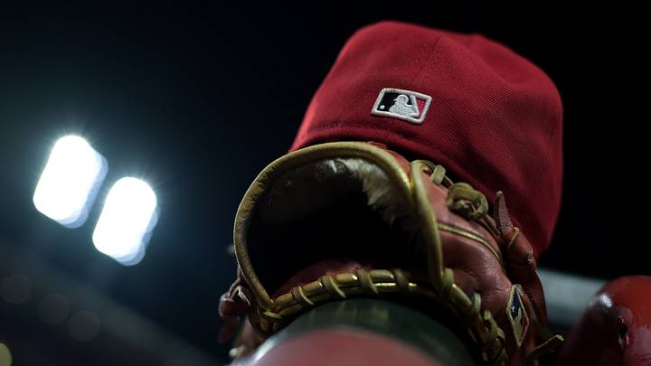 Aug 31, 2026; Cincinnati, Ohio, USA; The MLB logo on the field hat of a Cincinnati Reds player is seen resting on the dugout railing during the game against the San Diego Padres at Great American Ball Park. Mandatory Credit: Aaron Doster-Imagn Images Aug 31, 2026; Cincinnati, Ohio, USA; The MLB logo on the field hat of a Cincinnati Reds player is seen resting on the dugout railing during the game against the San Diego Padres at Great American Ball Park. Mandatory Credit: Aaron Doster-Imagn Images