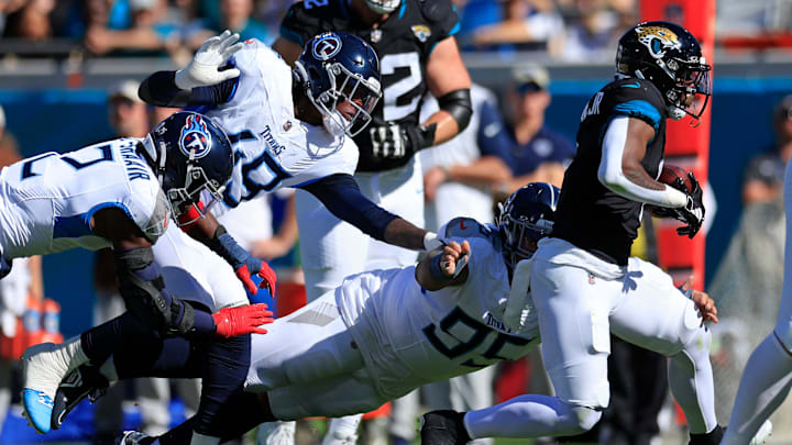 Jacksonville Jaguars running back Travis Etienne Jr. (1) outpaces Tennessee Titans defensive tackle