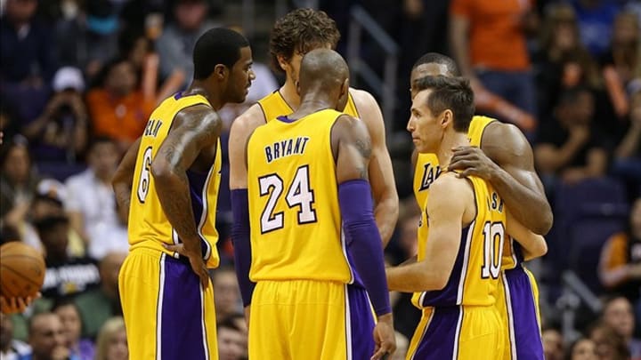 Los Angeles Lakers guard Steve Nash (10) and Kobe Bryant (24) in the huddle with teammates in the second half against the Phoenix Suns. Los Angeles Lakers guard Steve Nash (10) and Kobe Bryant (24) in the huddle with teammates in the second half against the Phoenix Suns.