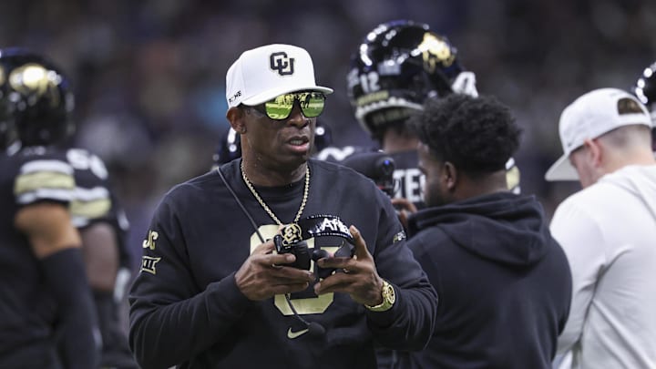 Dec 28, 2024; San Antonio, TX, USA; Colorado Buffaloes head coach Deion Sanders walks on the field between plays during the first quarter against the Brigham Young Cougars at Alamodome. Mandatory Credit: Troy Taormina-Imagn Images