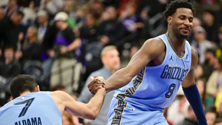Memphis Grizzlies forward Jaren Jackson Jr. (8) lifts up Memphis Grizzlies teammate Santi Aldama (7) after he was tripped during the second half against the Utah Jazz at Delta Center. Mandatory Credit: Peter Creveling-Imagn Images