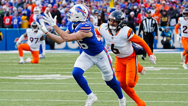 Buffalo Bills tight end Dalton Kincaid (86) puts his hands up and catches successfully the pass while Denver Broncos safety P.J. Locke (6) keeps pace with him during the second half of the Buffalo Bills wild card game against the Denver Broncos at Highmark Stadium in Orchard Park on Jan. 12, 2025. Buffalo Bills tight end Dalton Kincaid (86) puts his hands up and catches successfully the pass while Denver Broncos safety P.J. Locke (6) keeps pace with him during the second half of the Buffalo Bills wild card game against the Denver Broncos at Highmark Stadium in Orchard Park on Jan. 12, 2025.