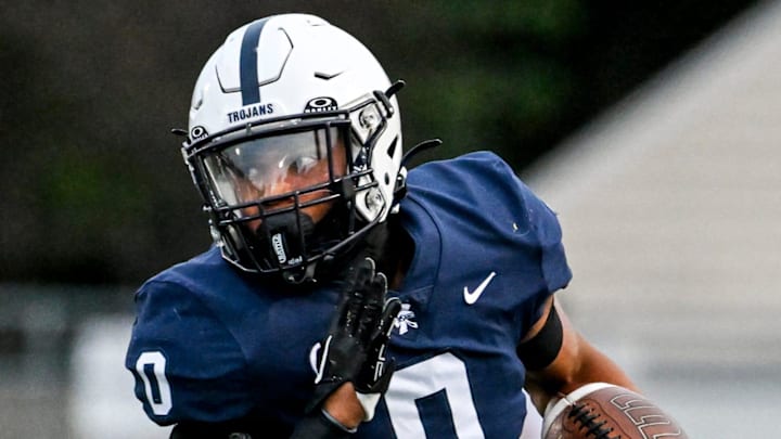 East Lansing's Jace Clarizio runs for a gain against DeWitt during the first quarter on Friday, Sept. 27, 2024, at East Lansing High School. East Lansing's Jace Clarizio runs for a gain against DeWitt during the first quarter on Friday, Sept. 27, 2024, at East Lansing High School.