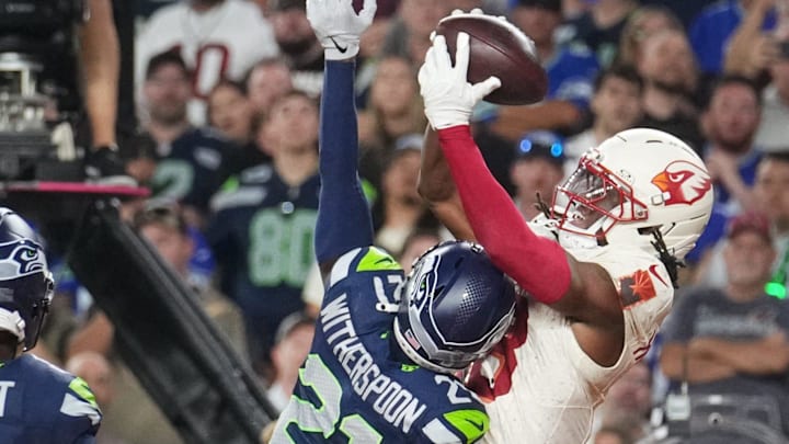 Cardinals receiver Marvin Harrison Jr. (18) catches a touchdown pass over the Seahawks' Devon Witherspoon in Week 4. Cardinals receiver Marvin Harrison Jr. (18) catches a touchdown pass over the Seahawks' Devon Witherspoon in Week 4.