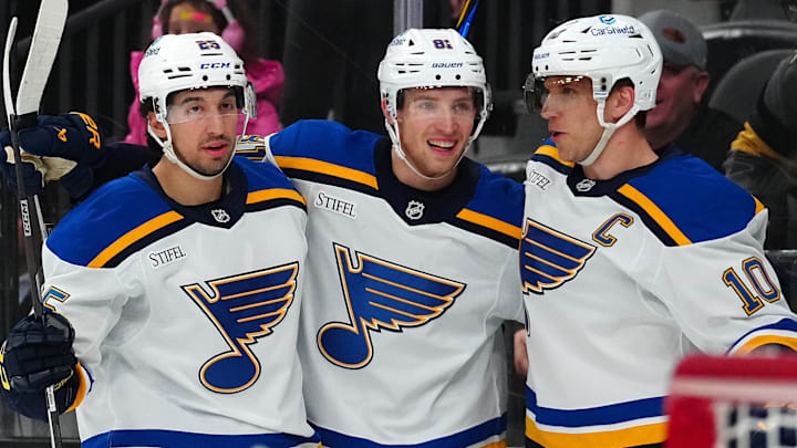Jan 20, 2025; Las Vegas, Nevada, USA; St. Louis Blues center Brayden Schenn (10) celebrates with center Dylan Holloway (81) and center Jordan Kyrou (25) after scoring a goal against the Vegas Golden Knights during the first period at T-Mobile Arena. Mandatory Credit: Stephen R. Sylvanie-Imagn Images