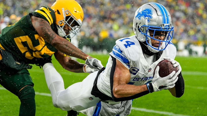 Detroit Lions wide receiver Amon-Ra St. Brown (14) makes a catch for a touchdown against Green Bay Packers cornerback Keisean Nixon (25) during the first half at Lambeau Field in Green Bay, Wis. on Sunday, Nov. 3, 2024.