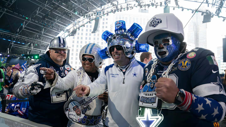 Dallas Cowboys fans pose in the main theater for the first day of the NFL Draft.