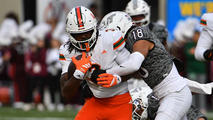 Nov 22, 2025; Blacksburg, Virginia, USA; Miami (FL) Hurricanes wide receiver Joshua Moore (3) runs after a catch as Virginia Tech Hokies safety Isaiah Cash (18) attempts to tackle during the second quarter at Lane Stadium. Mandatory Credit: Brian Bishop-Imagn Images