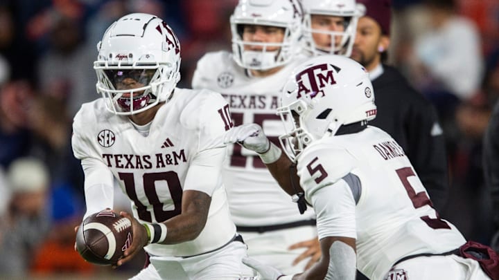 Texas A&M quarterback Marcel Reed hands the ball off to running back Amari Daniels during warmups before the Aggies' game against Auburn on Nov. 23, 2024, in Auburn, Ala.