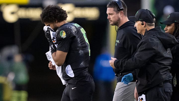 Oregon quarterback Dante Moore walks off the field holding his nose as the Oregon Ducks host the Wisconsin Badgers on Oct. 25, 2025, at Autzen Stadium in Eugene, Oregon. Oregon quarterback Dante Moore walks off the field holding his nose as the Oregon Ducks host the Wisconsin Badgers on Oct. 25, 2025, at Autzen Stadium in Eugene, Oregon.