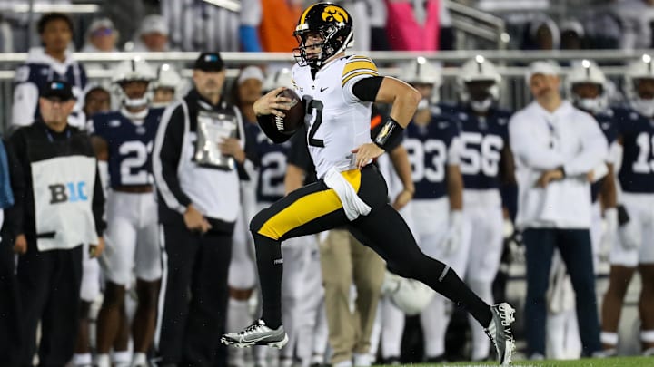Sep 23, 2023; University Park, Pennsylvania, USA; Iowa Hawkeyes quarterback Cade McNamara (12) runs with the ball during the first quarter against the Penn State Nittany Lions at Beaver Stadium. Mandatory Credit: Matthew O'Haren-USA TODAY Sports