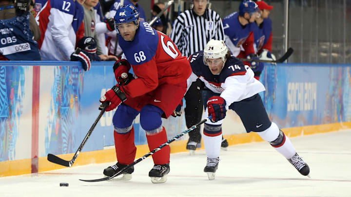 Feb 19, 2014; Sochi, RUSSIA; Czech Republic forward Jaromir Jagr (68) controls the puck against USA forward T.J. Oshie (74) in the men's ice hockey quarterfinals during the Sochi 2014 Olympic Winter Games at Shayba Arena. Mandatory Credit: Winslow Townson-Imagn Images