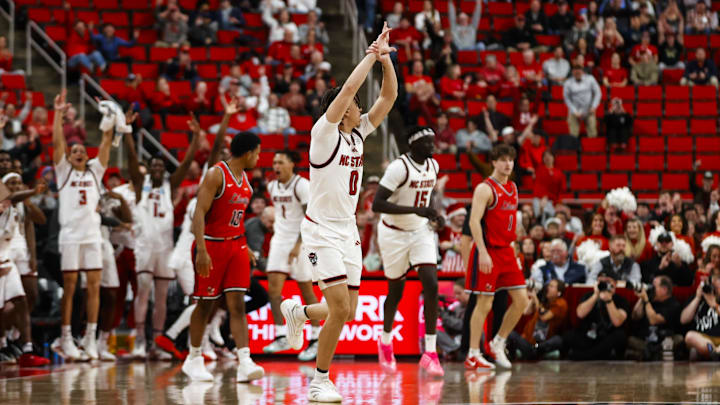 Dec 6, 2025; Raleigh, North Carolina, USA;NC State Wolfpack guard Jordan Snell (0) celebrates a three point shot during the second half of the game against the Liberty Flames at Lenovo Center. Mandatory Credit: Jaylynn Nash-Imagn Images