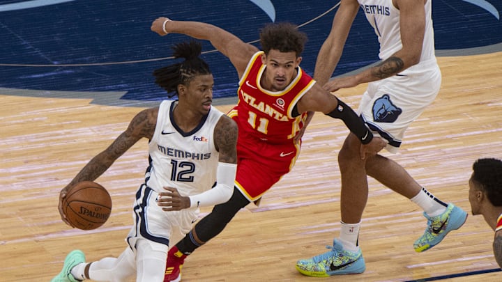 Memphis Grizzlies guard Ja Morant (12) handles the ball against Atlanta Hawks guard Trae Young (11) during the first half  at FedExForum. Mandatory Credit: Justin Ford-Imagn Images