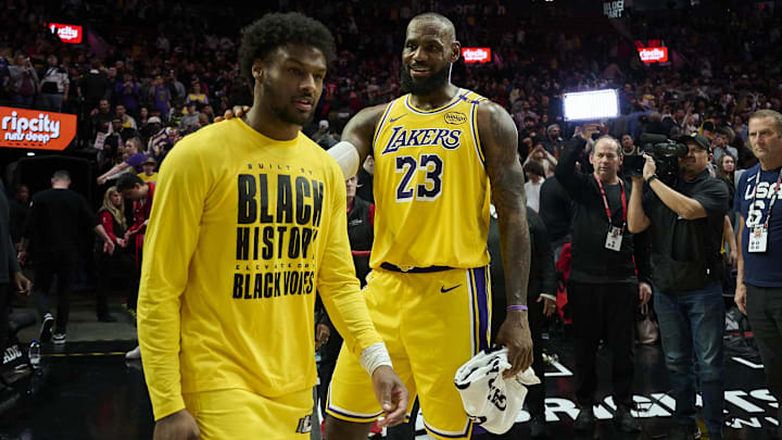 Feb 20, 2025; Portland, Oregon, USA; Los Angeles Lakers forward LeBron James (23) celebrates victory over the Portland Trail Blazers with his son guard Bronny James (9) at Moda Center. Mandatory Credit: Troy Wayrynen-Imagn Images