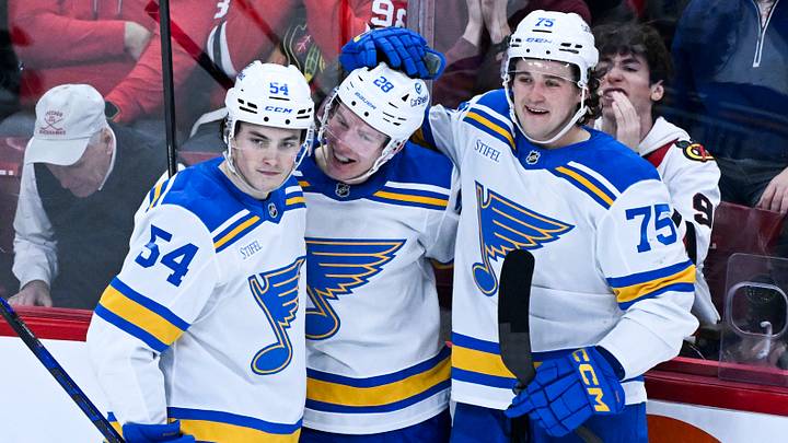 Jan 7, 2026; Chicago, Illinois, USA; St. Louis Blues center Otto Stenberg (28) celebrates with right wing Dalibor Dvorsky (54) and  defenseman Tyler Tucker (75) after scoring against the Chicago Blackhawks during the second period at the United Center. Mandatory Credit: Matt Marton-Imagn Images