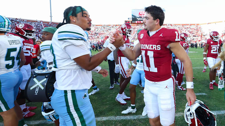 Sep 14, 2024; Norman, Oklahoma, USA;  Tulane Green Wave quarterback Darian Mensah (10) shakes hands with Oklahoma Sooners quarterback Jackson Arnold (11) after the game at Gaylord Family-Oklahoma Memorial Stadium.