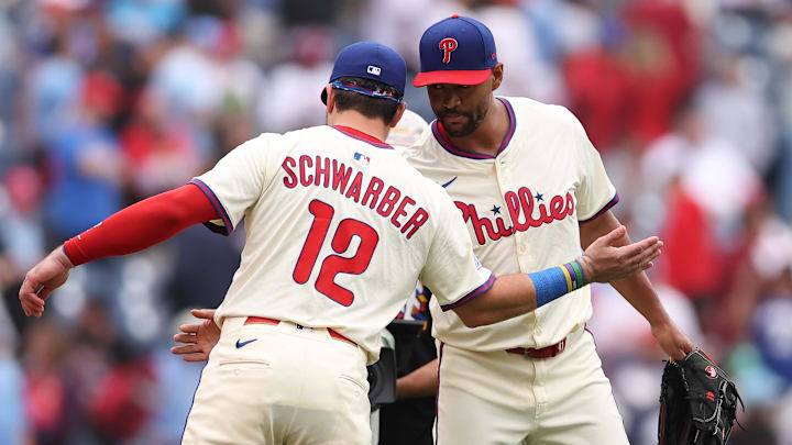 Aug 20, 2025; Philadelphia, Pennsylvania, USA; Philadelphia Phillies outfielder Kyle Schwarber (12) and pitcher Joe Ross (41) shake hands after a win against the Seattle Mariners at Citizens Bank Park. 