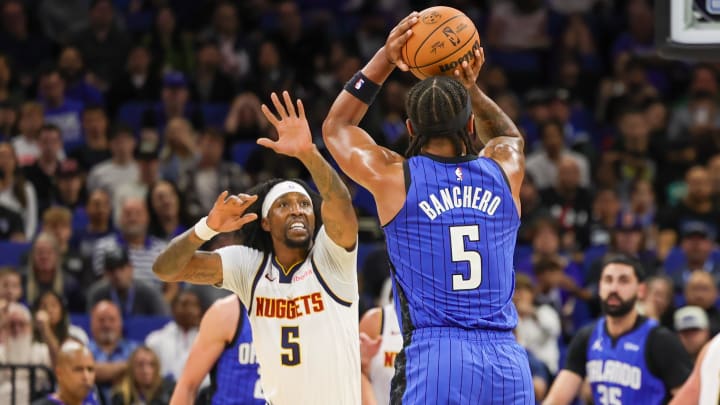 Orlando Magic forward Paolo Banchero (5) shoots the ball against Denver Nuggets guard Kentavious Caldwell-Pope (5) during the first quarter at Amway Center. Orlando Magic forward Paolo Banchero (5) shoots the ball against Denver Nuggets guard Kentavious Caldwell-Pope (5) during the first quarter at Amway Center.