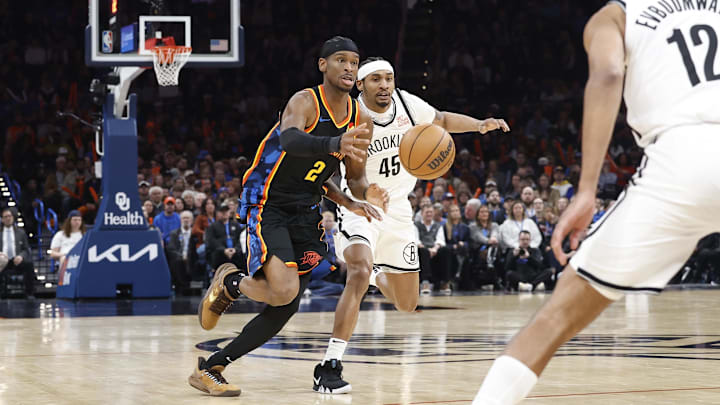 Jan 19, 2025; Oklahoma City, Oklahoma, USA; Oklahoma City Thunder guard Shai Gilgeous-Alexander (2) and Brooklyn Nets guard Keon Johnson (45) reach for a pass during the second half at Paycom Center. Mandatory Credit: Alonzo Adams-Imagn Images Jan 19, 2025; Oklahoma City, Oklahoma, USA; Oklahoma City Thunder guard Shai Gilgeous-Alexander (2) and Brooklyn Nets guard Keon Johnson (45) reach for a pass during the second half at Paycom Center. Mandatory Credit: Alonzo Adams-Imagn Images