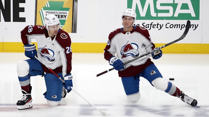 Oct 26, 2023; Pittsburgh, Pennsylvania, USA; Colorado Avalanche left wing Miles Wood (28) and center Ross Colton (20) stretch on the ice before the game against the Pittsburgh Penguins at PPG Paints Arena. Mandatory Credit: Charles LeClaire-Imagn Images