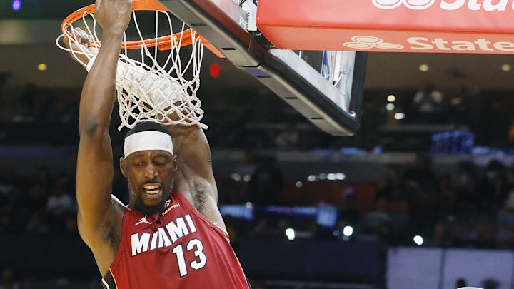 Mar 10, 2026; Miami, Florida, USA;  Miami Heat center Bam Adebayo (13) hangs on the rim after a dunk against the Washington Wizards during the first half at Kaseya Center. Mandatory Credit: Rhona Wise-Imagn Images