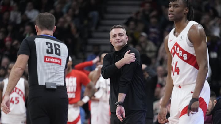 Feb 4, 2025; Toronto, Ontario, CAN; Toronto Raptors head coach Darko Rajakovic and guard Ja'Kobe Walter (14) react to a call by the officials during the second half against the New York Knicks at Scotiabank Arena. Mandatory Credit: John E. Sokolowski-Imagn Images