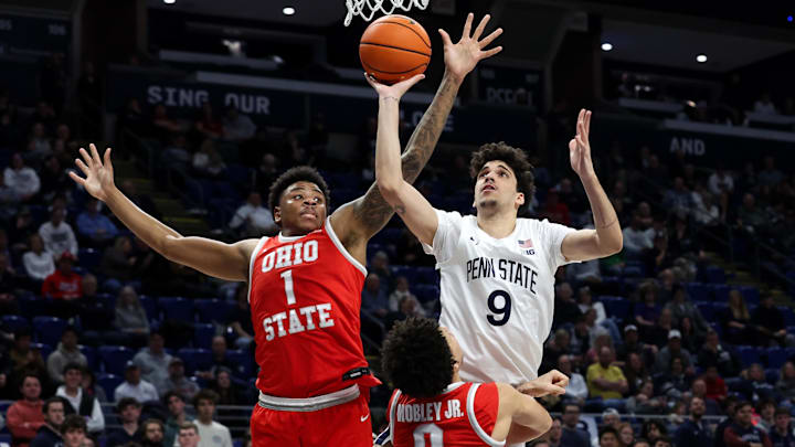 Mar 4, 2026; University Park, Pennsylvania, USA; Penn State Nittany Lions guard Melih Tunca (9) drives the ball to the basket as Ohio State Buckeyes guard John Mobley Jr (0) and forward Amare Bynum (1) defend during the first half at Bryce Jordan Center. Mandatory Credit: Matthew O'Haren-Imagn Images