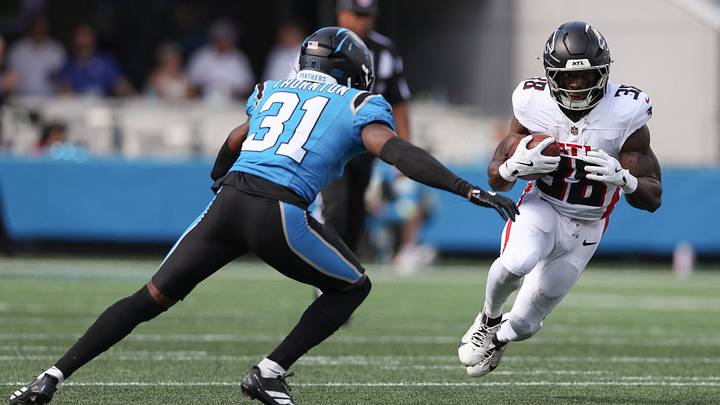 Sep 21, 2025; Charlotte, North Carolina, USA; Atlanta Falcons running back Nate Carter (38) carries the ball while defended by Carolina Panthers cornerback Corey Thornton (31) during the second half at Bank of America Stadium. Mandatory Credit: Cory Knowlton-Imagn Images