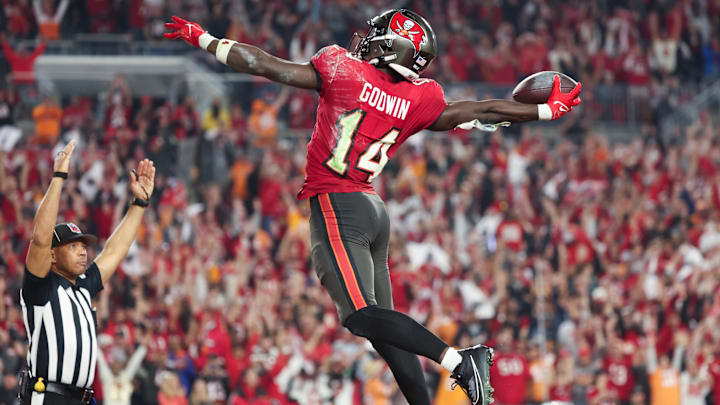 Jan 15, 2024; Tampa, Florida, USA; Tampa Bay Buccaneers wide receiver Chris Godwin (14) celebrates his touchdown against the Philadelphia Eagles during the second half of a 2024 NFC wild card game at Raymond James Stadium. 